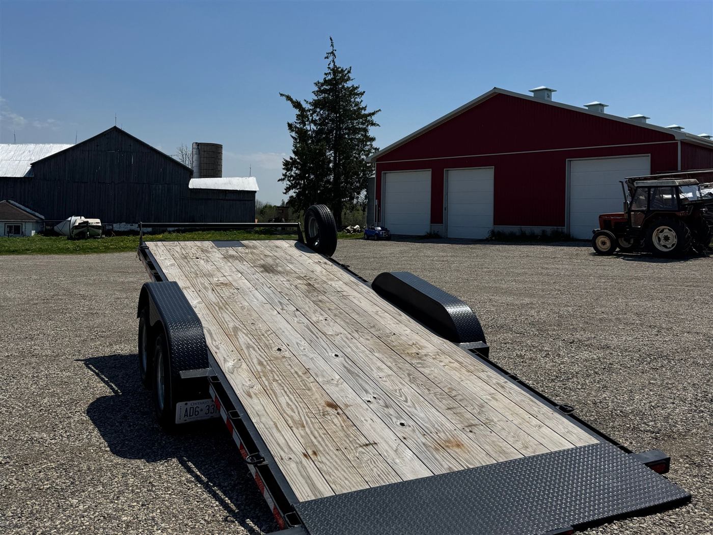 Power tilt trailer loaded with equipment